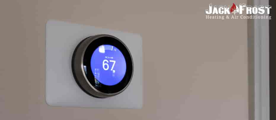 Smart thermostat on a wall.